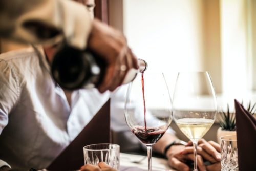 server pouring wine